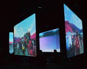Six screens are hung in a large dark space with an impressively large sound track, disorienting the viewer as to which part of the horror to watch - Richard Mosse: The Enclave (2013). Photo: Mick 2015.